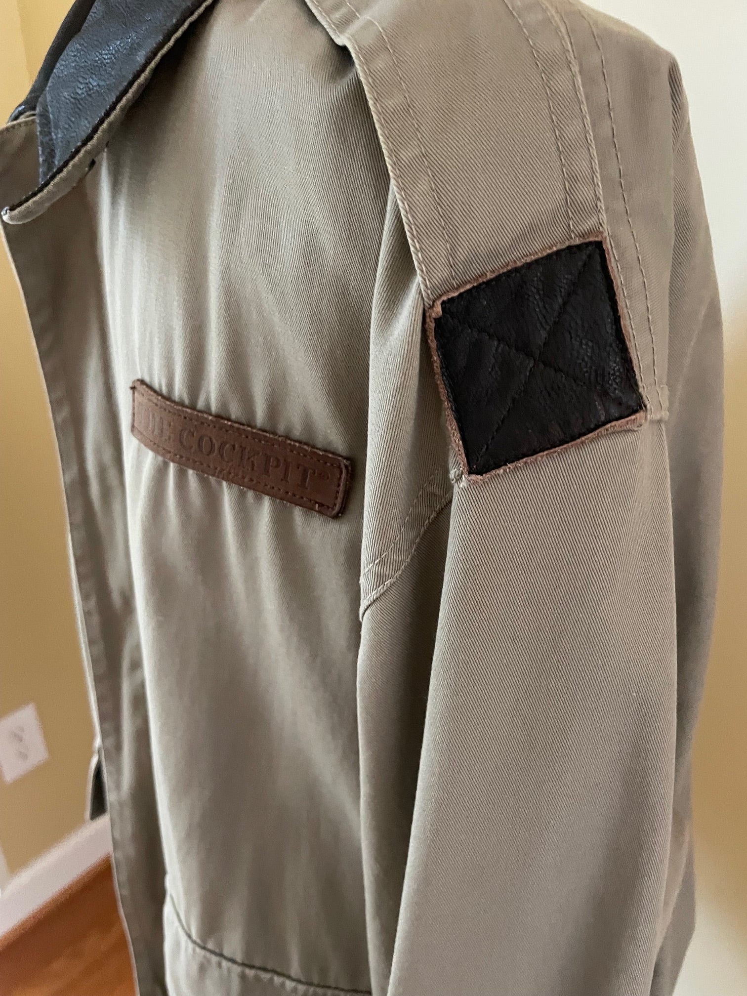 Close-up of canvas jacket sleeve and epaulette and 'COCKPIT' leather name strip