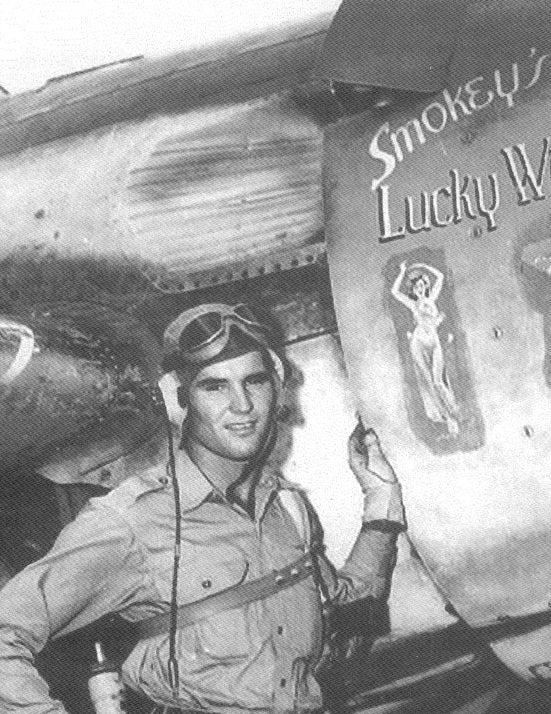 A WWII Navy Wildcat with artwork 'Smokey's Lucky Witch' featuring two lovely pinup images glued to the engine cowling