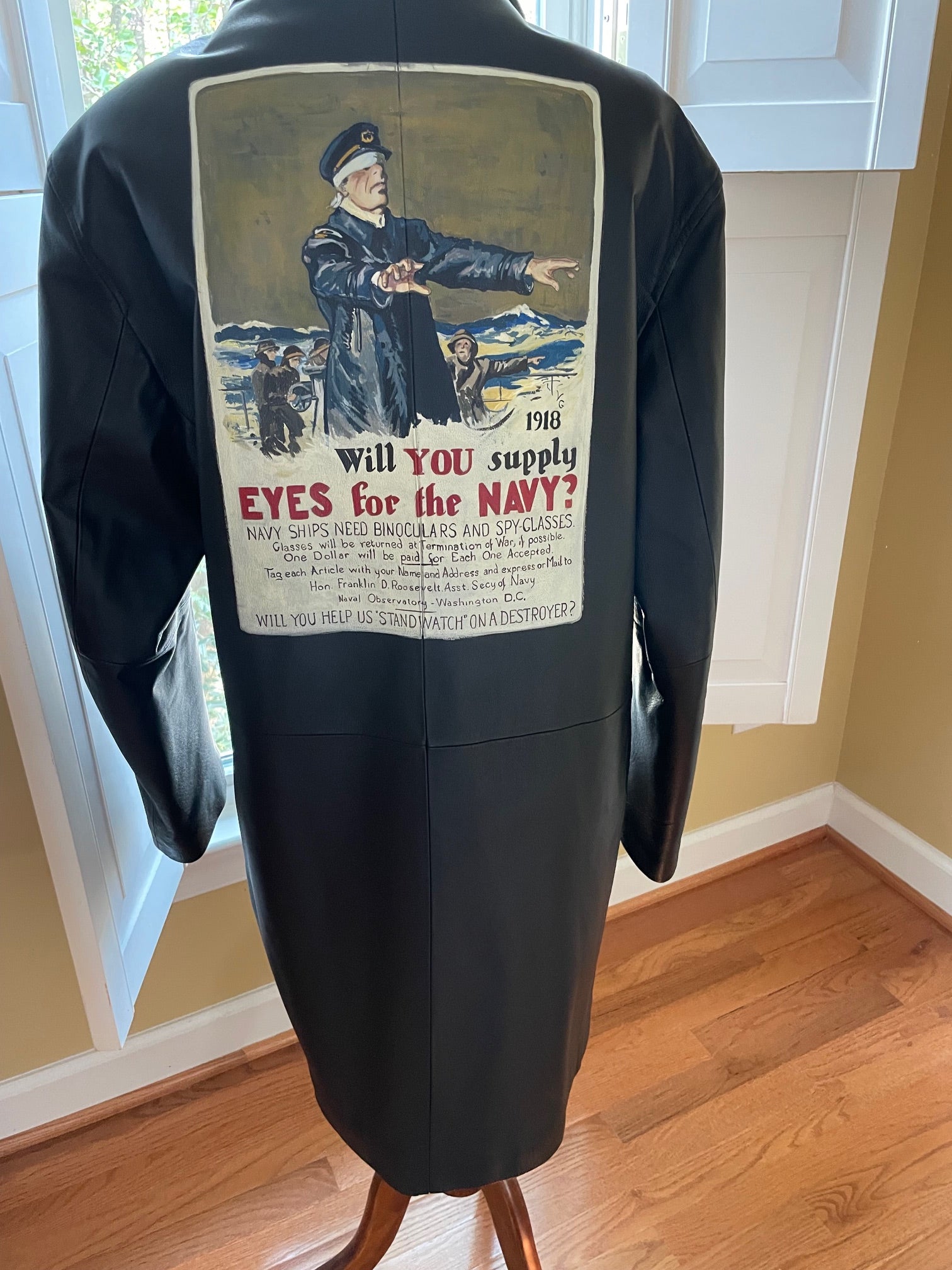 Black leather jacket with a vintage-style hand painted 'eyes for the navy' design on back