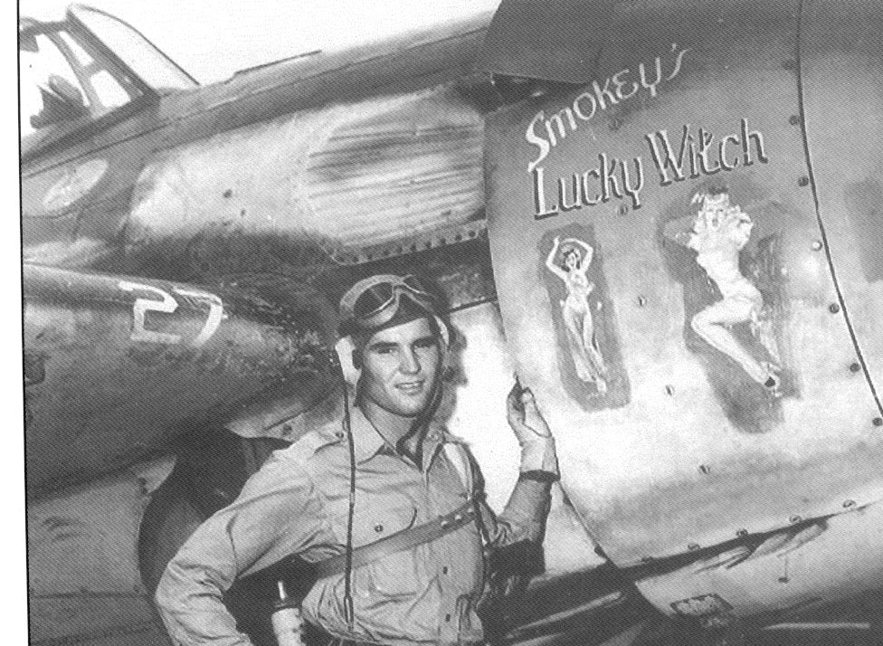 A WWII  Navy Wildcat with artwork 'Smokey's Lucky Witch' featuring two lovely pinup images glued to the engine cowling